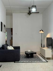 a living room with a couch and a table at Kemaman AY Home in Cukai