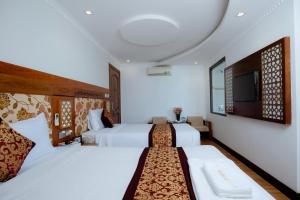 Postel nebo postele na pokoji v ubytování A9 Beach Hotel Da Nang