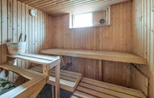 a wooden sauna with a bench and a window at Beautiful Home In Torup With Sauna in Torup +19 photos