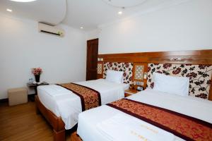 Postel nebo postele na pokoji v ubytování A9 Beach Hotel Da Nang