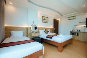 Postel nebo postele na pokoji v ubytování A9 Beach Hotel Da Nang
