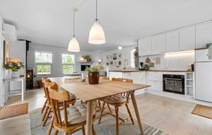 a kitchen with a wooden table and chairs at 4 Bedroom Lovely Home In Rønde in Rønde