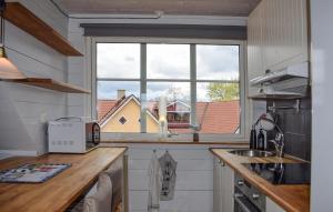 a kitchen with a large window and a sink at Pet Friendly Apartment In Degeberga in Degeberga