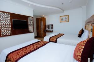 Postel nebo postele na pokoji v ubytování A9 Beach Hotel Da Nang