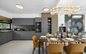 a kitchen and dining room with a table and chairs at Me Paradise Villa Lavender in Tribunj