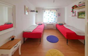 a room with two beds and a window at Pet Friendly Home In Söderköping in Söderköping