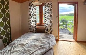 a bedroom with a bed and a large window at Pet Friendly Home In Söderköping in Söderköping