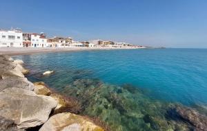 a beach with clear blue water and white buildings at 2 Bedroom Gorgeous Apartment In Moncofa in Moncófar