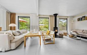 a living room with a couch and a table at 3 Bedroom Gorgeous Home In Højby in Højby
