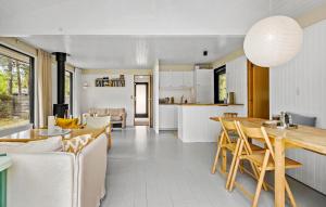 a kitchen and living room with a table and chairs at 3 Bedroom Gorgeous Home In Højby in Højby