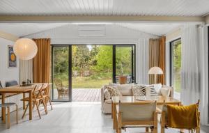 a living room with a couch and a table at 3 Bedroom Gorgeous Home In Højby in Højby