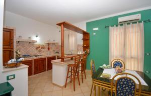 a kitchen with a table and chairs and a dining room at Gorgeous Home In Acate in Acate