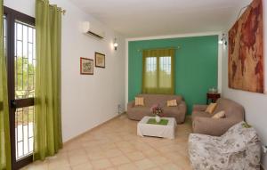 a living room with a couch and a table at Gorgeous Home In Acate in Acate