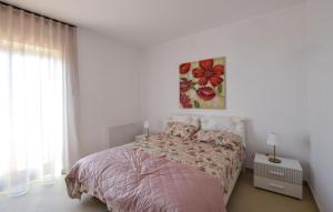 a bedroom with a bed and a painting on the wall at L'onda Dolce in Diamante