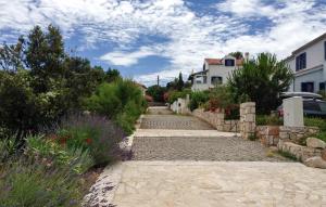 a stone walkway in front of a house at 1 Bedroom Lovely Apartment In Nerezine in Nerezine +11 photos