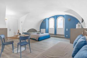 a bedroom with a bed and a table and chairs at Kalimera alla Rocca di Manerba in Montinelle