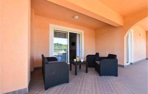 a room with chairs and a table and a window at Stunning Apartment In Dubravice in Dubravice