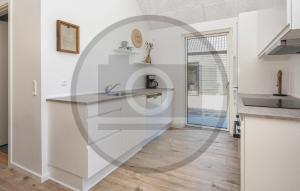 a kitchen with white walls and a counter top at 4 Bedroom Amazing Home In Glesborg in Glesborg