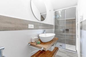 a bathroom with a sink and a mirror at Kalimera alla Rocca di Manerba in Montinelle