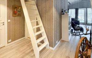 a wooden staircase in a living room with a room at 4 Bedroom Nice Home In Åmli in Åmli