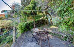 a table and chairs sitting next to a fence at Nice Apartment In Recco With Wifi in Recco