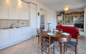 a kitchen and dining room with a wooden table and chairs at Nice Apartment In Recco With Wifi in Recco