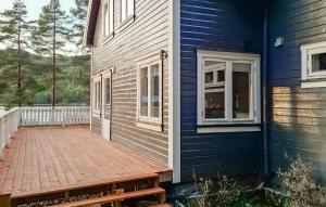 a blue house with a wooden deck in front of it at 4 Bedroom Beautiful Home In Fyresdal in Fyresdal +14 photos