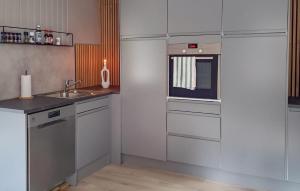a small kitchen with a sink and a microwave at 4 Bedroom Beautiful Home In Fyresdal in Fyresdal
