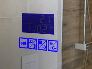 a clock on a wall with blue signs on it at Beach House nr 69 in Ouddorp +39 photos