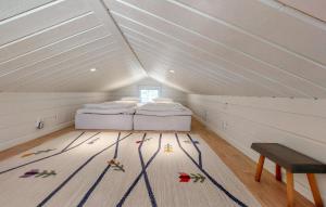 a attic room with two beds and a table at Amazing Home In Holmseryd With Wifi in Jälluntofta