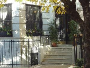 a house with a wrought iron fence and stairs at The Gallery House in New York