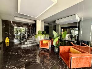 a lobby with couches and chairs and a staircase at SA Apartments! 150m to the Cleopatra Beach in Alanya