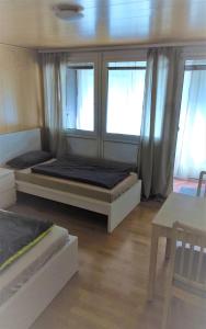 a bedroom with two beds and two windows at Monteurwohnung 5 Hoffmann in Heilbronn