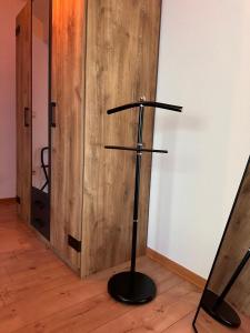 a black stand in a room with a wooden door at Dachnest mit Charme in Niederdorla