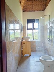 a bathroom with a sink and a toilet at Bwindi Neckview Lodge in Buhoma