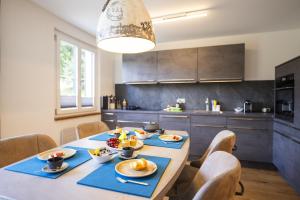 a kitchen with a table with plates of food on it at Chasa Valambrun 1001 in Vulpera