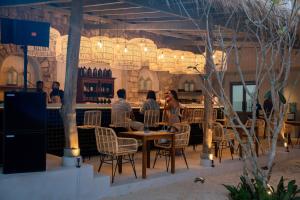 a group of people sitting at a table in a restaurant at Serendipity Mirissa in Mirissa +45 photos