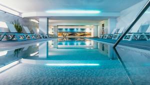 a swimming pool with blue lighting in a building at Labranda Marieta & Spa - Adults Only in Playa del Ingles