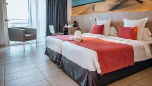 a hotel room with a large bed with red and white pillows at Labranda Marieta & Spa - Adults Only in Playa del Ingles