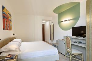 Ένα ή περισσότερα κρεβάτια σε δωμάτιο στο Rina Hotel