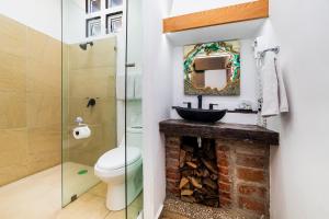 a bathroom with a sink and a toilet and a mirror at Collection O Casa Anzures Thematic, Mexico City in Mexico City