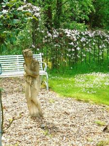 a statue of a bear standing next to a bench at The Old Coach House in Bungay +2 photos