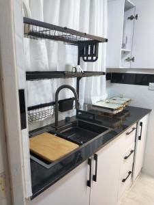 a kitchen with a sink and a counter top at Serenity in Ongata Rongai 