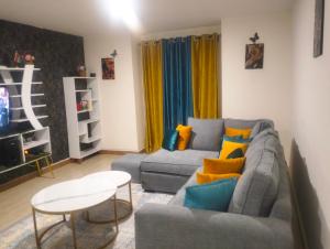 a living room with a couch and a table at Serenity in Ongata Rongai 