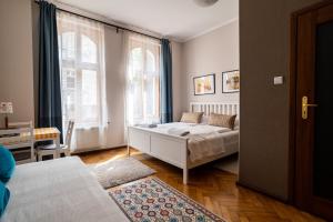 Postel nebo postele na pokoji v ubytování Victus Apartamenty, Apartament Aurora