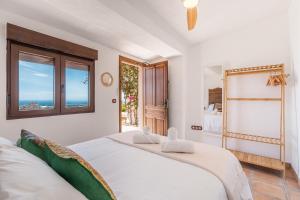 a bedroom with a bed with a view of the ocean at Finca La Haima in Motril +30 photos