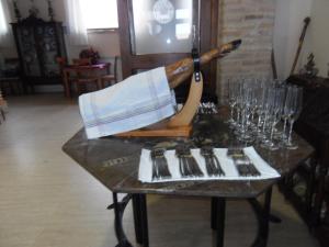 a table with forks and wine glasses on it at Domus Viatoris in Sahagún