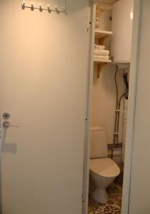 a bathroom with a toilet and a white door at Cozy container, Österlen in Skillinge +24 photos
