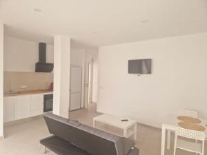 a living room with a couch and a table at playa son moll 2 in Cala Ratjada