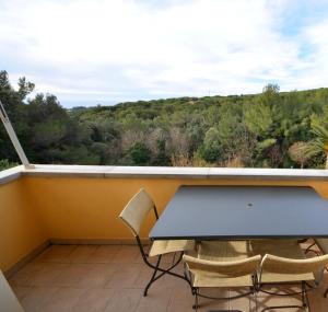 a table and chairs on a balcony with a view at Appartamento vista mare in Castiglioncello +12 photos